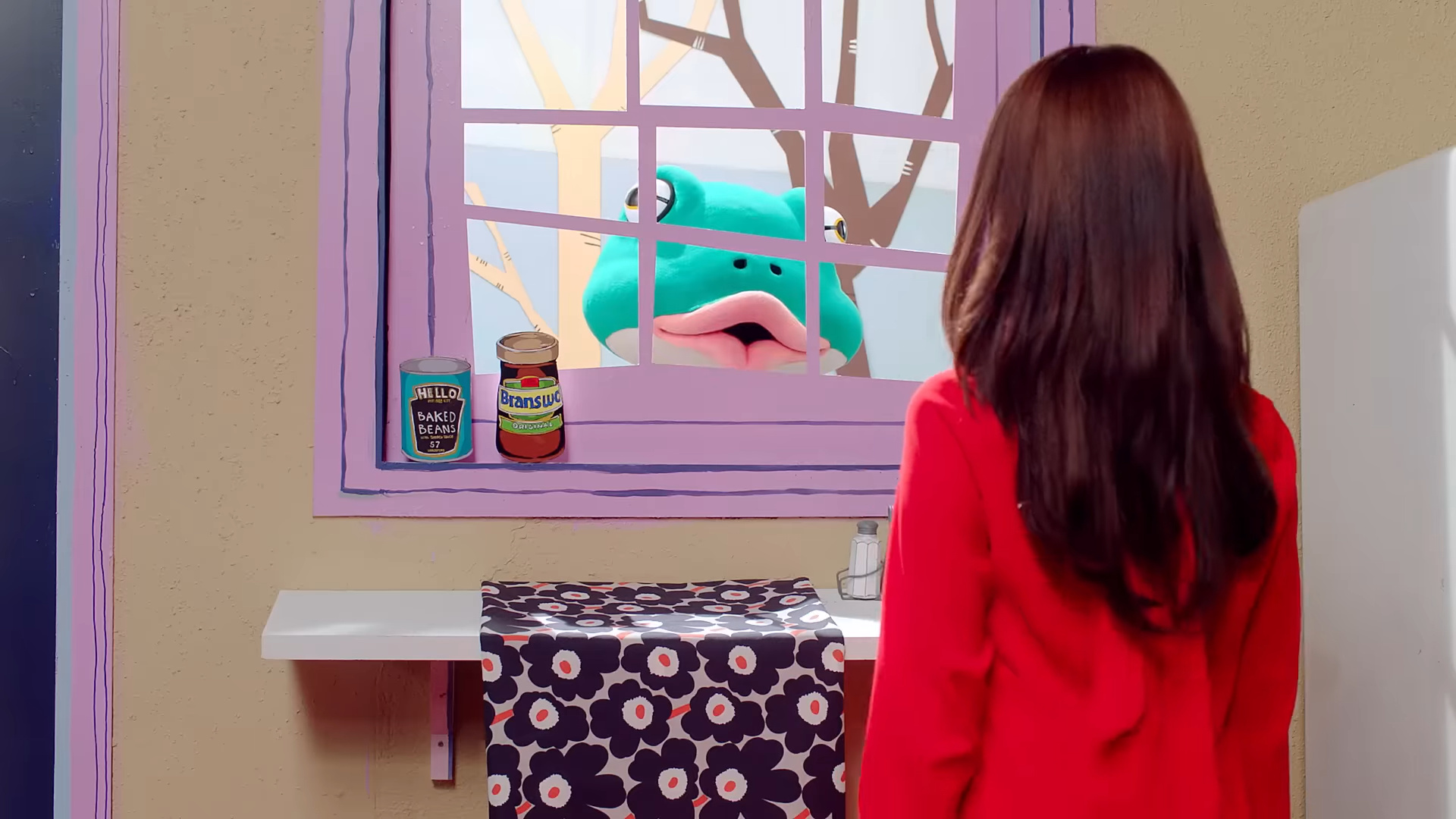 The frog standing outside the window.